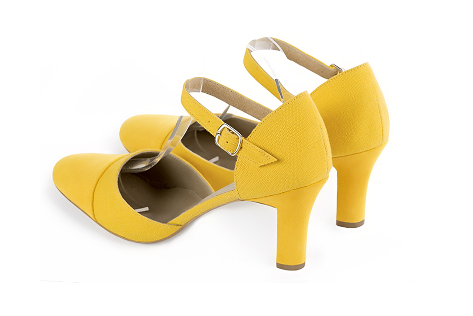 Women's yellow open side dress shoes, with an instep strap. Round toe. High kitten heels - Rear view